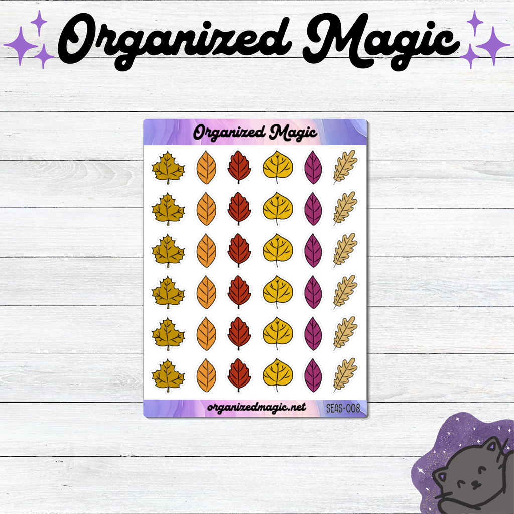 An autumn-themed planner sticker sheet from Organized Magic, featuring colorful doodle maple leaves and acorns in yellow, orange, red, and purple, displayed on a white wood plank background.