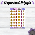 An autumn-themed planner sticker sheet from Organized Magic, featuring colorful doodle maple leaves and acorns in yellow, orange, red, and purple, displayed on a white wood plank background.