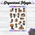 A sheet of planner stickers featuring cute black cats in autumn-themed poses, displayed on a white wood background with decorative purple branding text reading 'Organized Magic'.