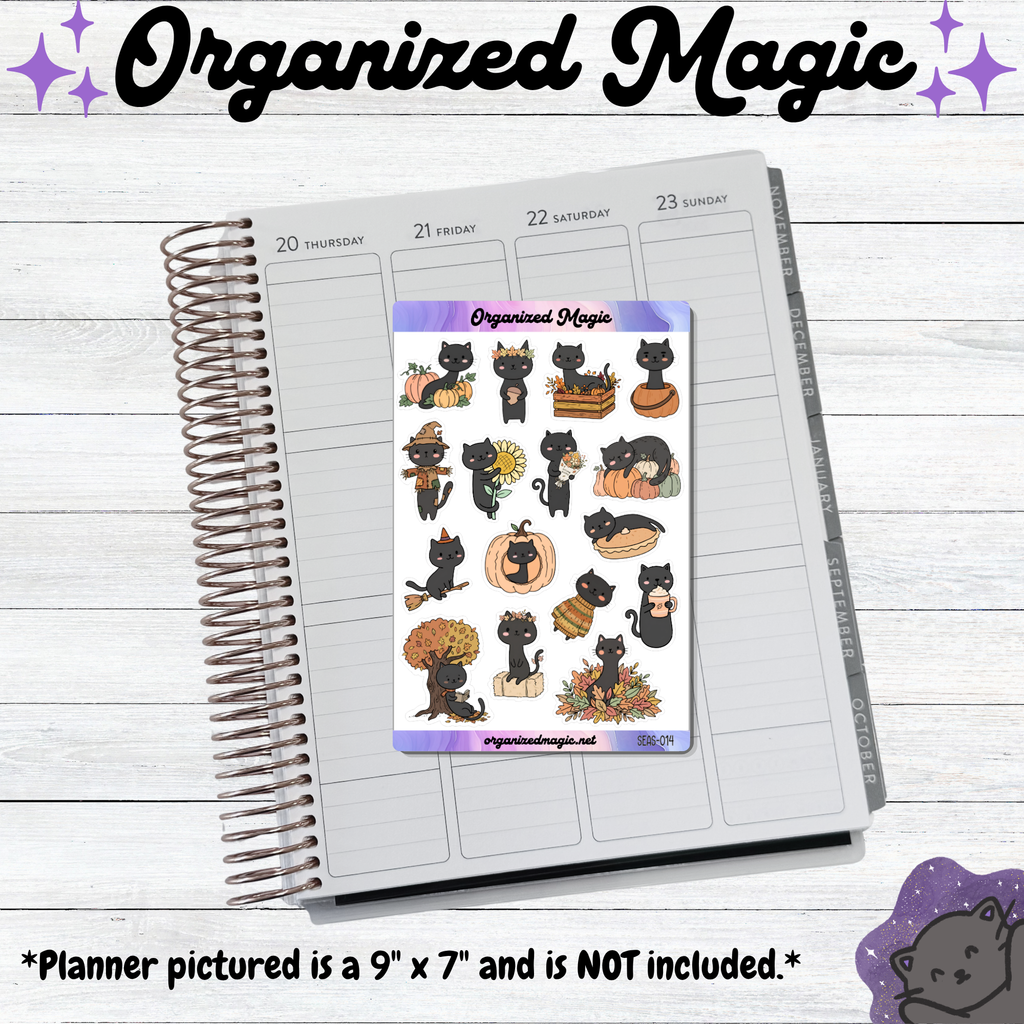 A spiral-bound planner page shown on a whitewashed wood background, with a sticker sheet featuring cute black cats in autumn-themed illustrations placed on the page. The sticker sheet is branded 'Organized Magic' and includes text noting the planner pictured is 9 x 7 inches and not included.