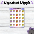 A sticker sheet from Organized Magic featuring rows of cute Halloween-themed coffee cup planner stickers, displayed on a white wood background with the brand name 'Organized Magic' at the top.