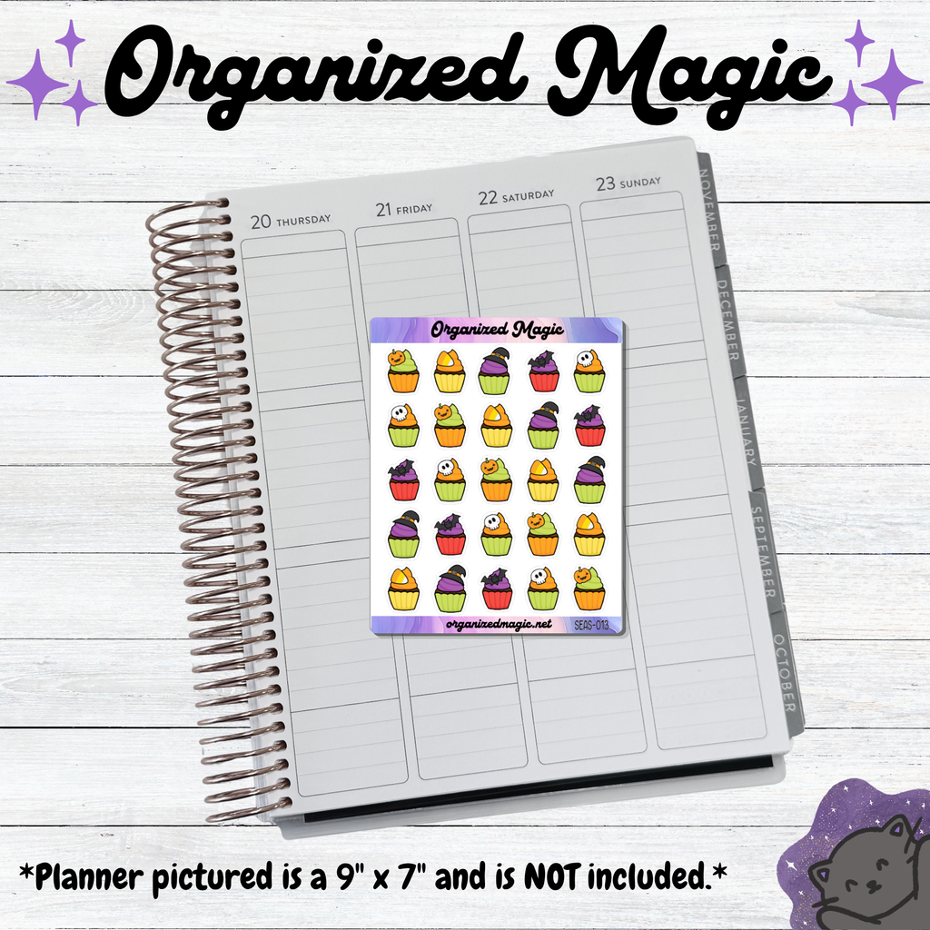A rectangular sticker sheet featuring five rows of five small Halloween-themed cupcake illustrations displayed on an open planner. The cupcakes are decorated with ghosts, pumpkins, bats, and witch hats in orange, purple, green, and black. The text Organized Magic is at the top.