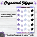 Star planner sticker sheet from Organized Magic on a light wood background. The sheet contains rows of large star stickers in lavender, light purple, white, and black, with text noting that the large star stickers measure approximately 0.75 inces.